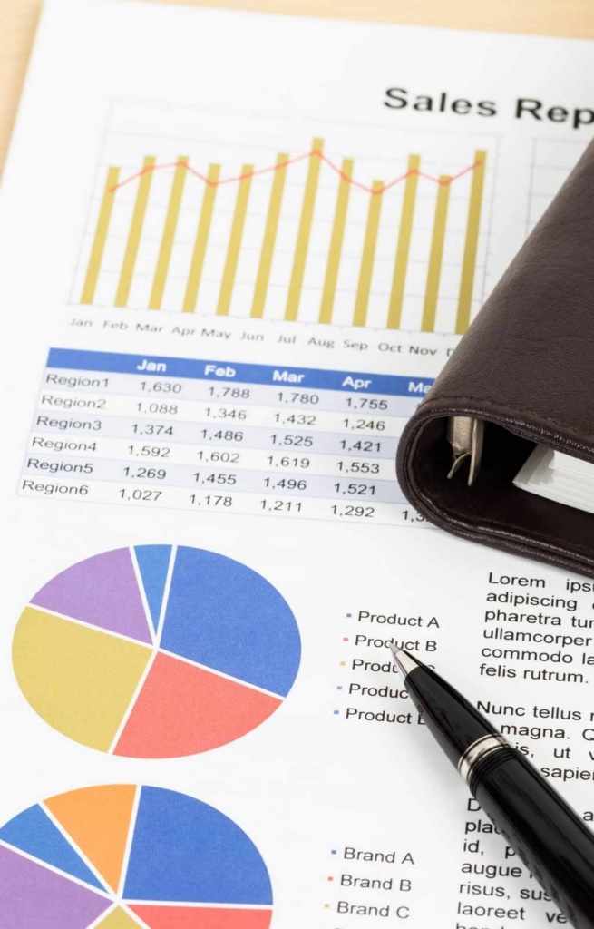 Sales report on a desk with pen and folder
